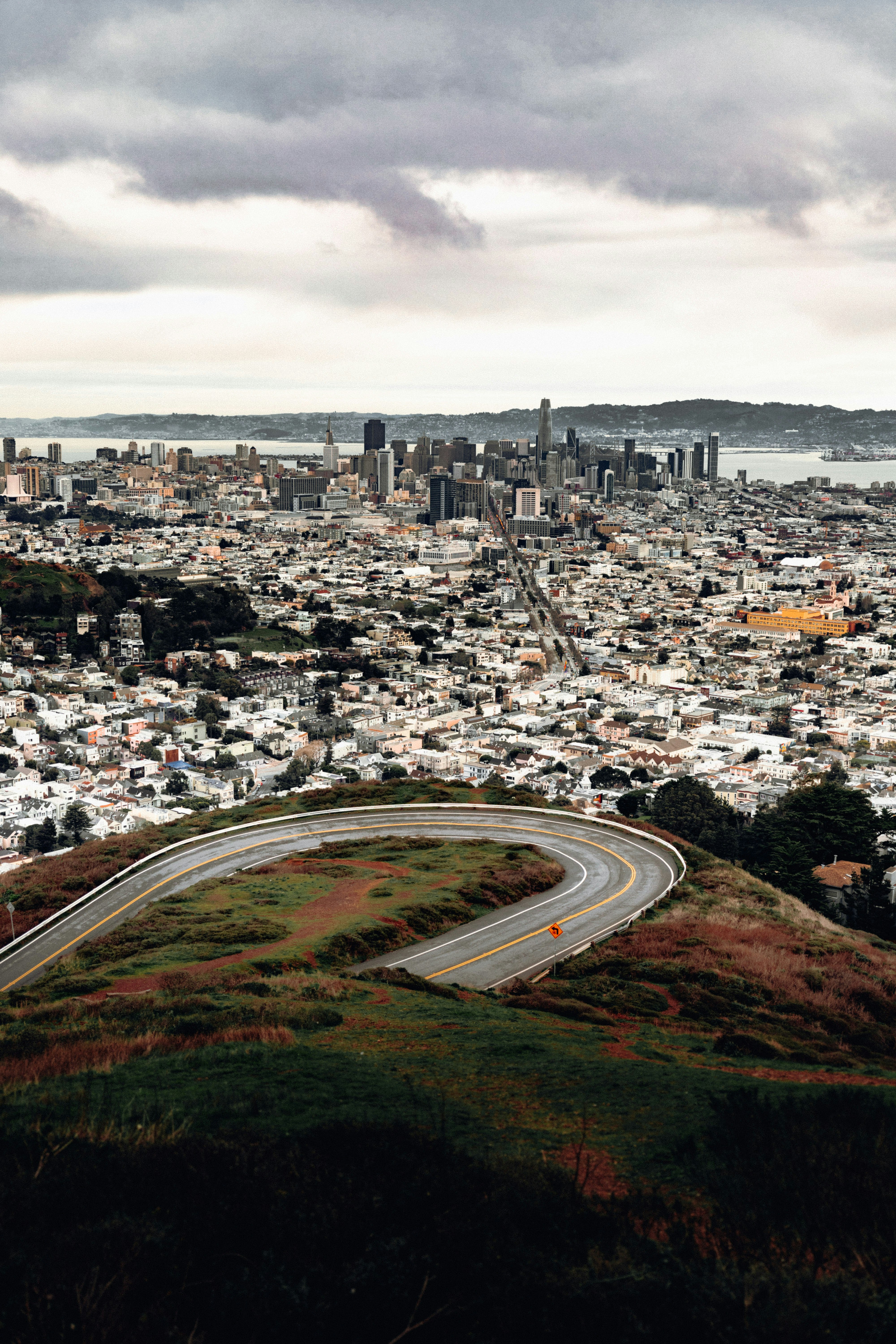 high-angle photo of city buildings and gray pavement road